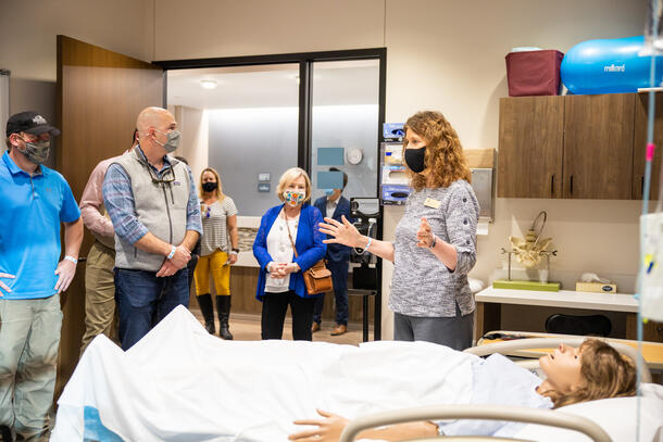 Dr. Kimbrow talking to a group of people touring the nursing simulation lab