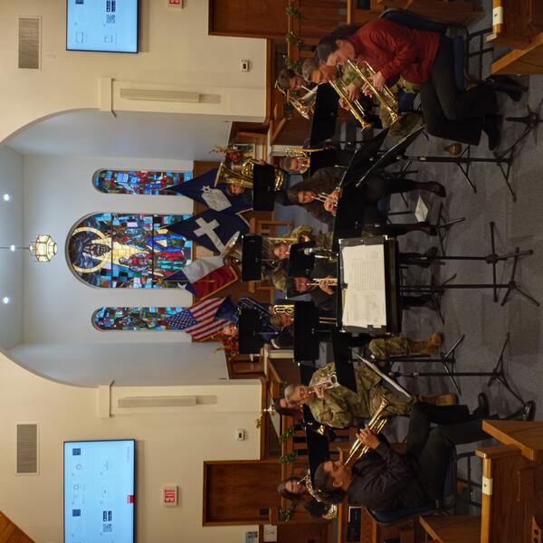 Brass ensemble playing with soldiers at Camp Mabry