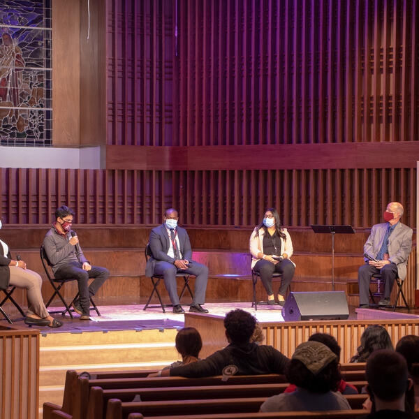 Group of 4 Southwestern Adventist University faculty/staff and 2 students sitting socially distanced on a stage