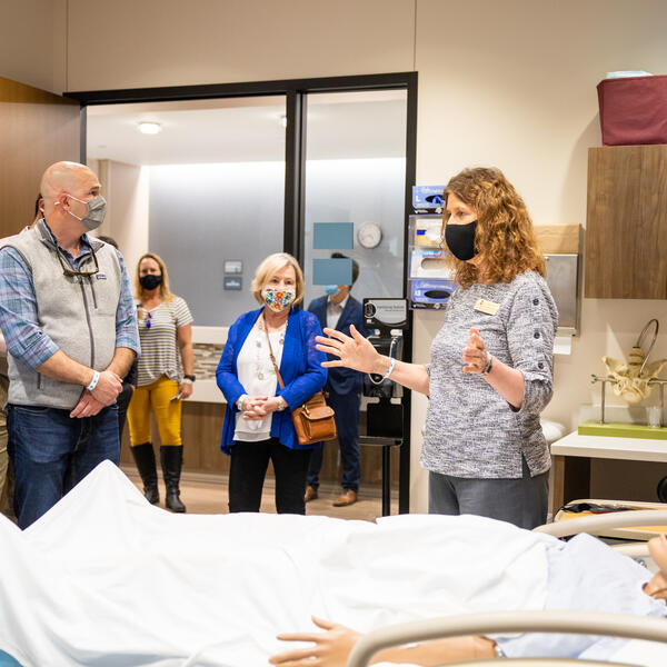 Dr. Kimbrow talking to a group of people touring the nursing simulation lab