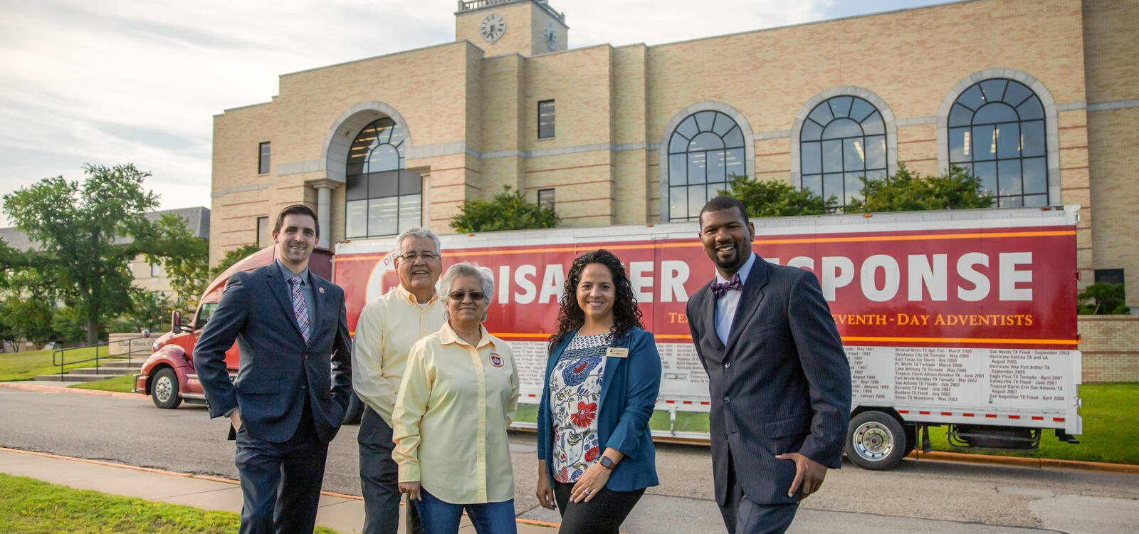 Group of five people standing in front of the Disaster Response trailer