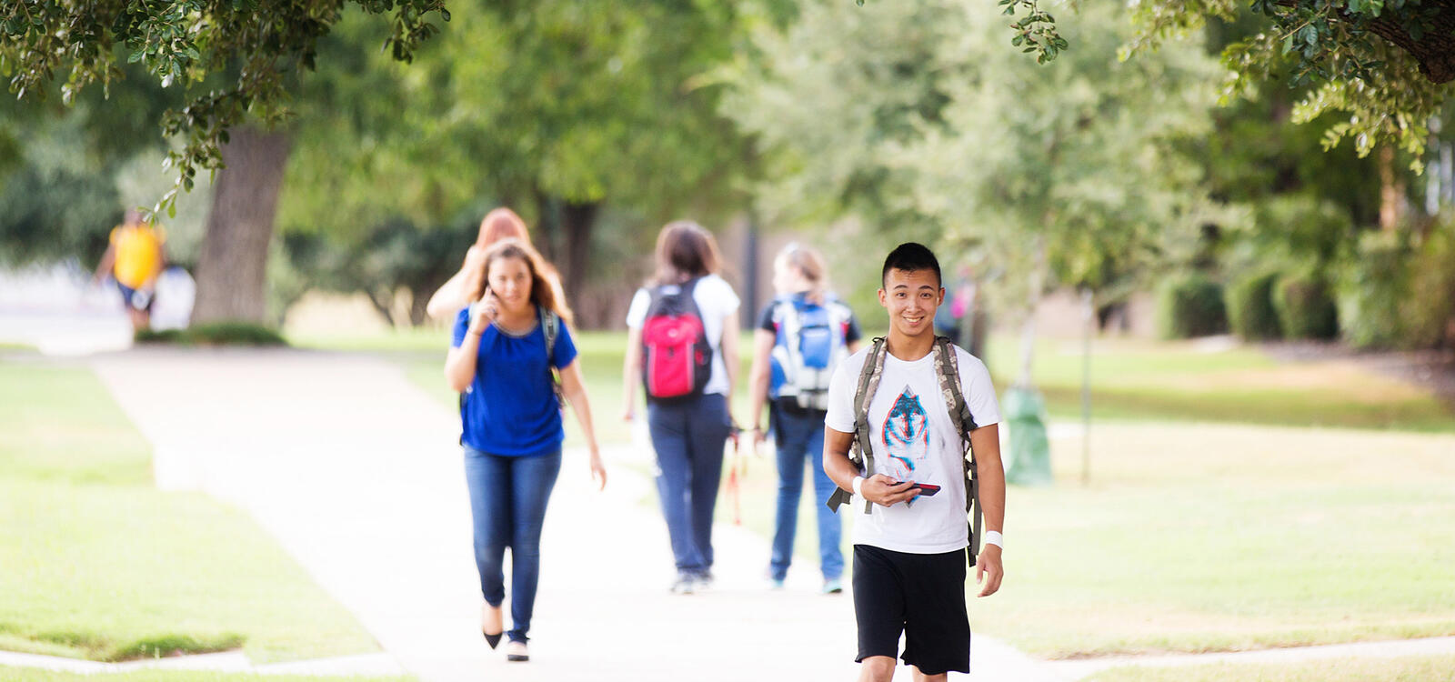 Outside on the sidewalks, students can be seen in the background walking to and from class