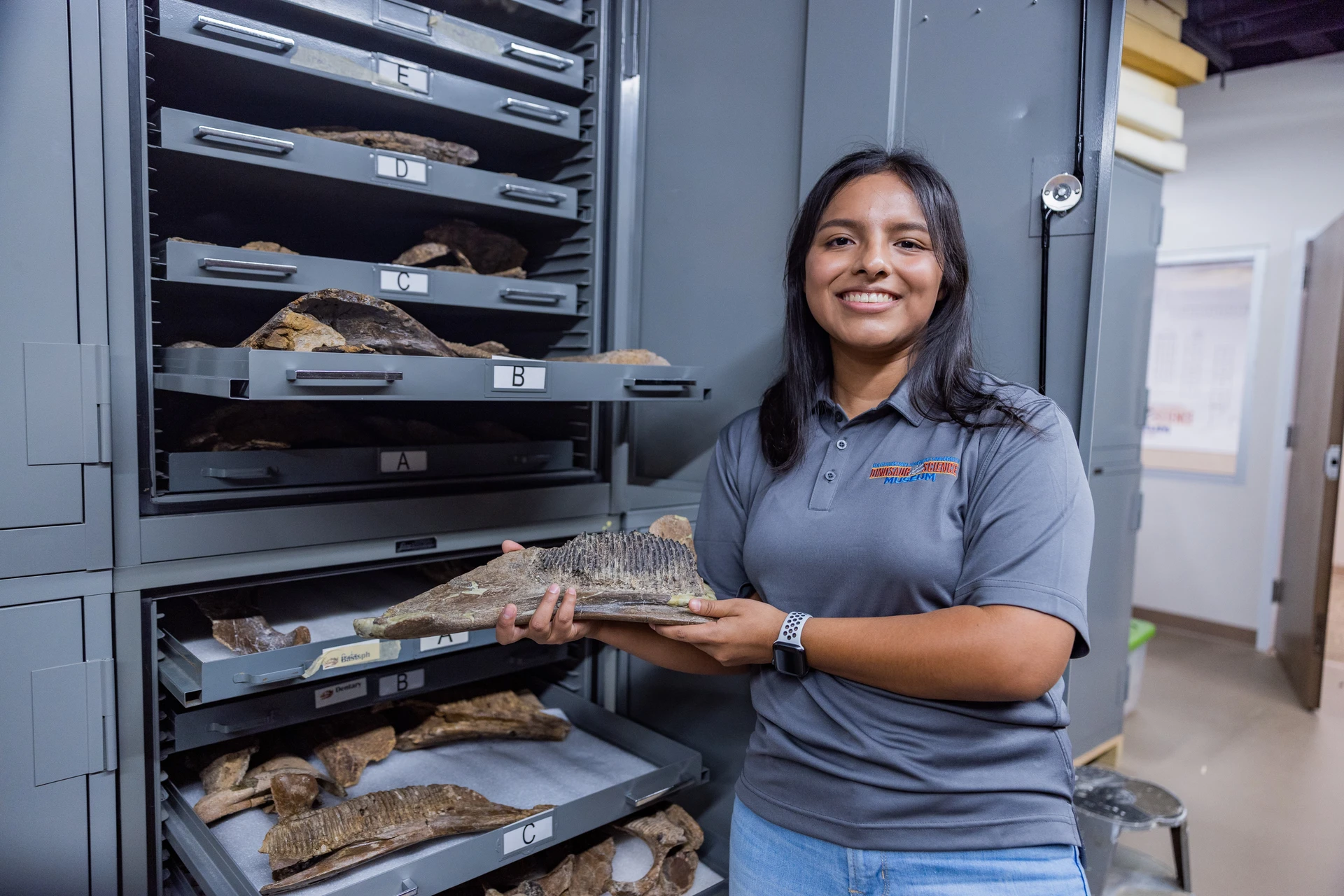 Dinosaur Science Museum student smiling at repository SWAU