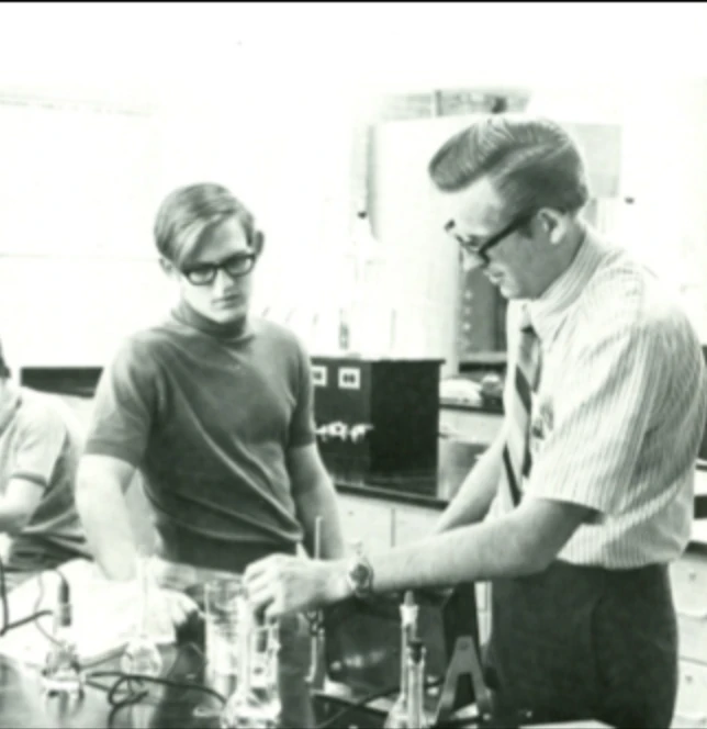 Dr. Karl Konrad explaining something to a student in the Southwestern Adventist University chemistry lab