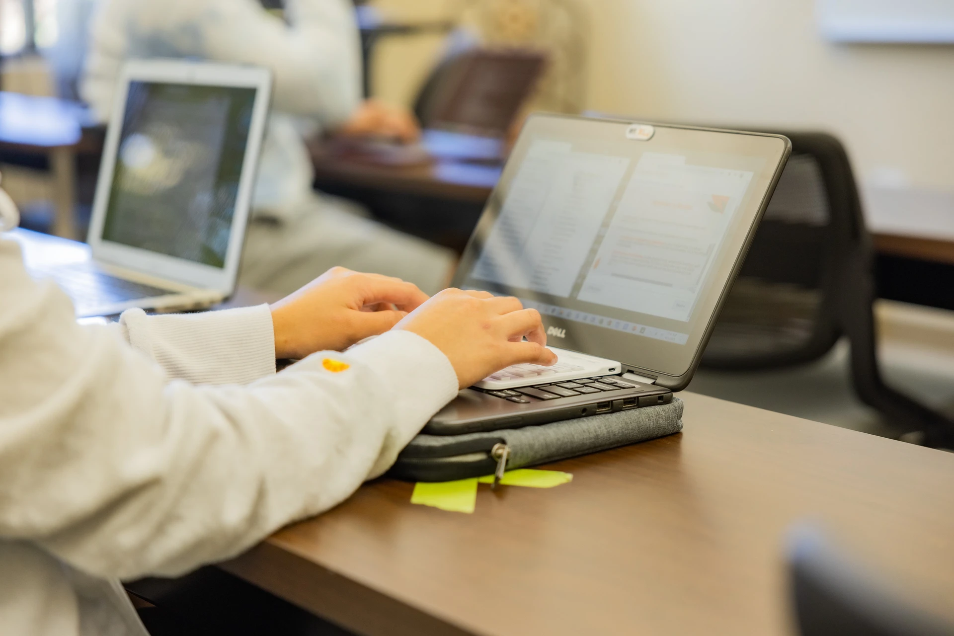 SWAU student with laptop taking notes in classroom