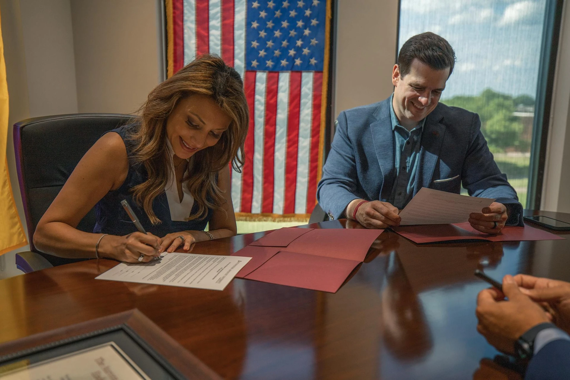 The Vallettas look over and sign papers for their endowment